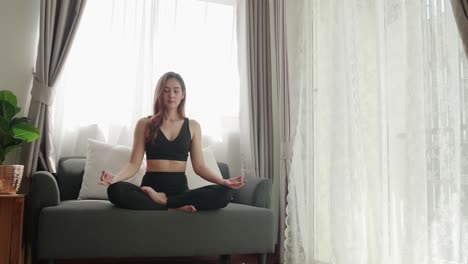 asian women relax with yoga exercise and stretching in the living room