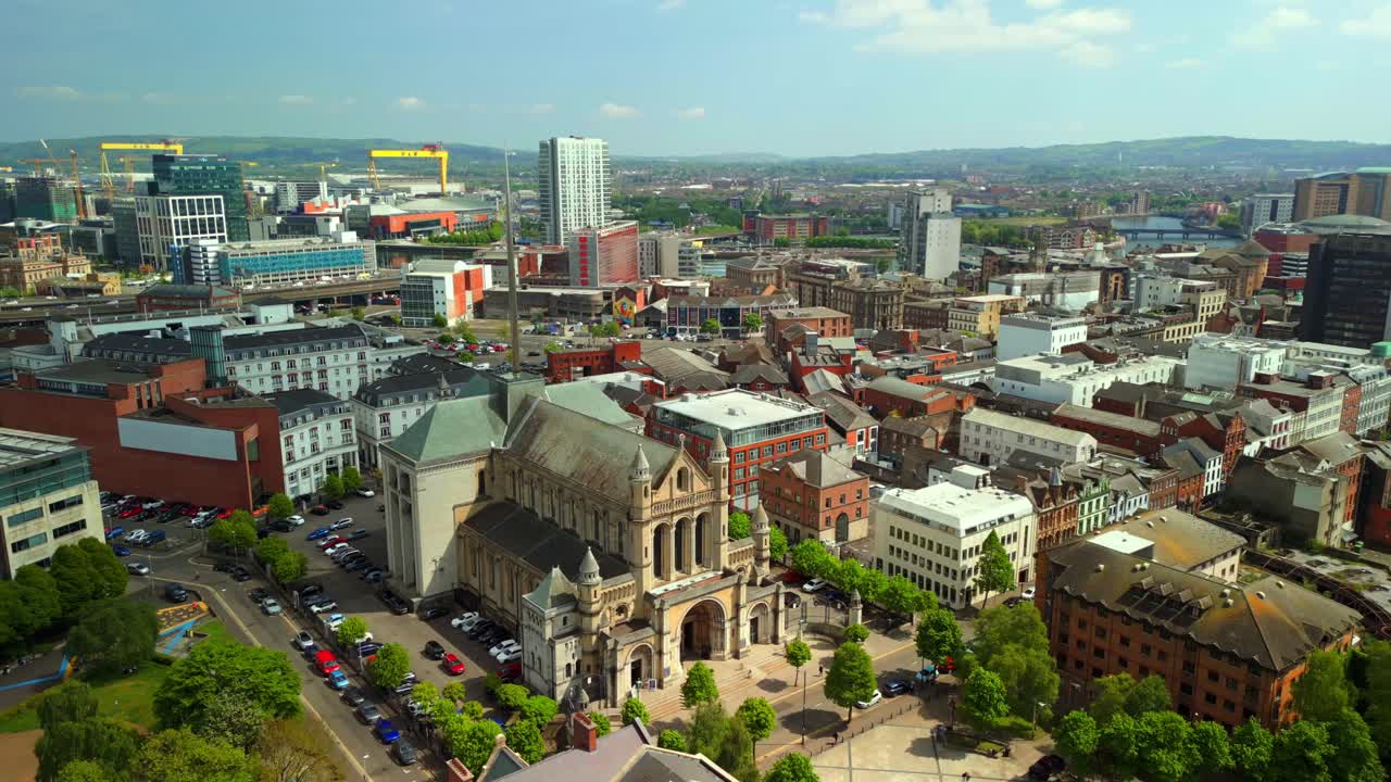 Reversing and ascending aerial video of St Anne's Cathedral in the Cathedral Quarter in Belfat City Centre, Northern Ireland on a bright and sunny day. Filmed in 4K, 60FPS and with Rec709 Color.