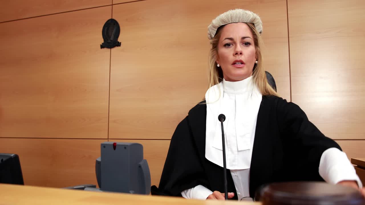 Judge speaking while banging gavel on sounding block