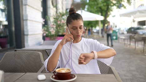 young woman talking on phone in a cafe