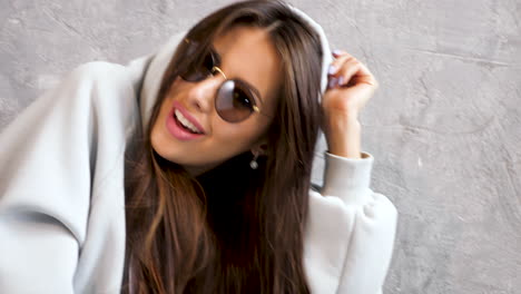 woman in hoodie and sunglasses