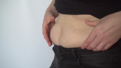 side view of woman with fat belly