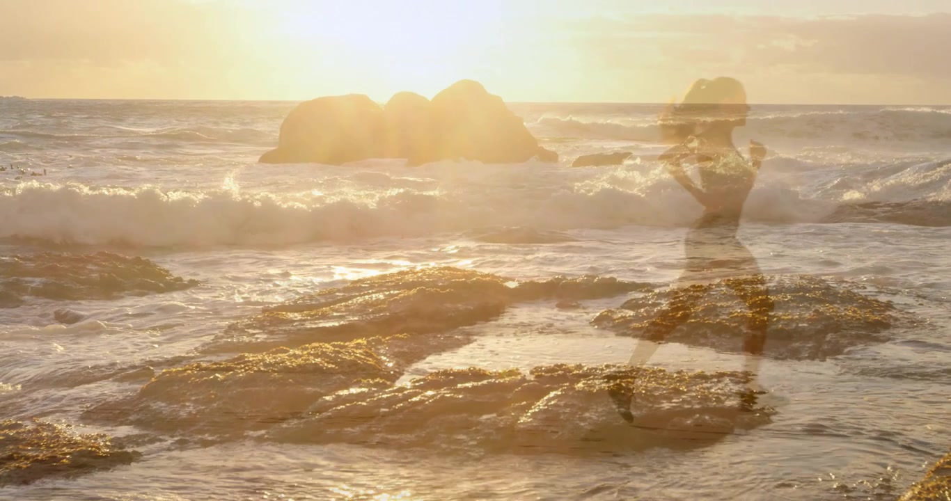 Woman walking rocks, sun backlight revealing then fading silhouette, making marketing visuals