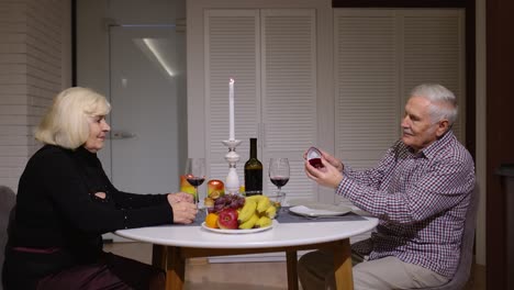 elderly couple having romantic dinner with candlelight