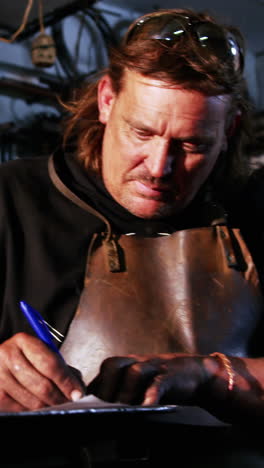 welder working on blueprint