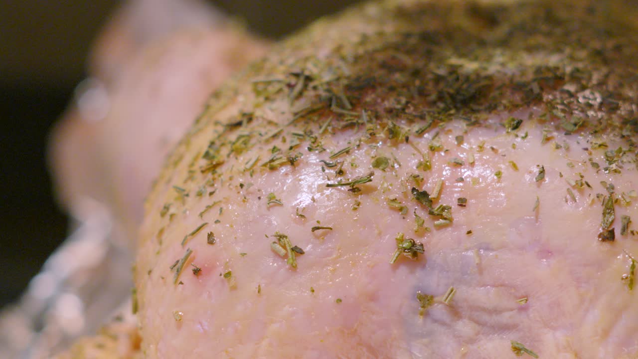 Close Up of Raw Whole Free Range Chicken Being Seasoned with Herbs Tumbling Down in Slow Motion. Cooking Food Footage 4K.