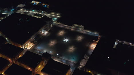 Aerial-orbit-night-view-of-Praca-do-Comercio-square-and-Arco-da-Rua-Augusta-monument-in-urban-city-center-of-Lisbon,-Portugal