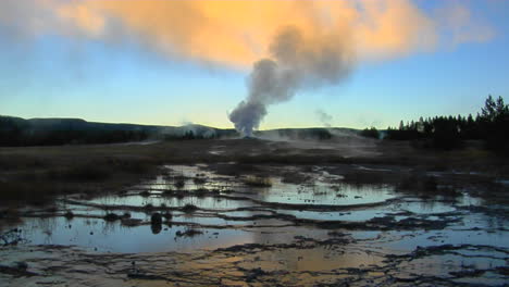 a geyser sends steam into the sky at yellowstone national park 1