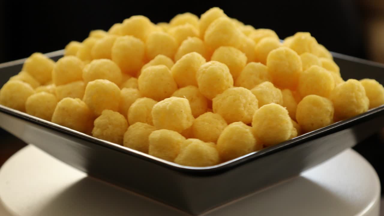 Puffed golden cheese balls rotating 4
