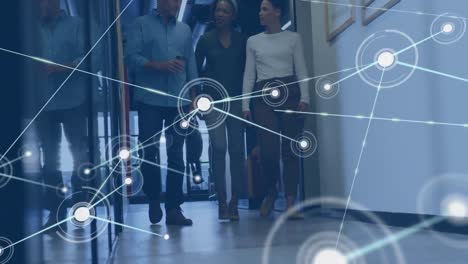animation of network of connections over diverse team of colleagues discussing together at office
