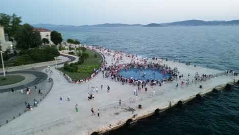 Vista-Panorámica-De-Drones-De-La-Costa-Del-Mar-Del-Monumento-Al-Atardecer-De-Zadar