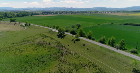 Aerial-View-Of-Two-Bicyclist-Cycling-In-Mountains