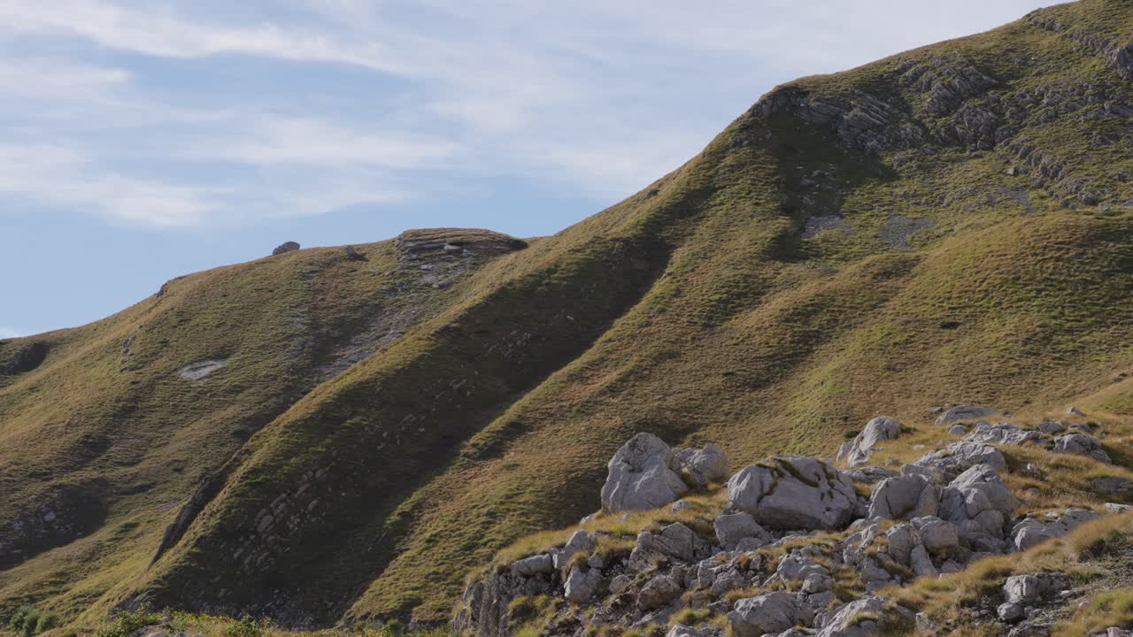 Rolling hills in Durmitor with blue sky evoke tranquility