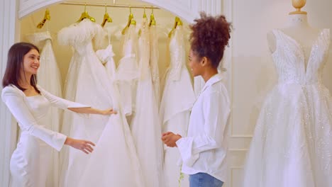 bride trying on wedding dresses