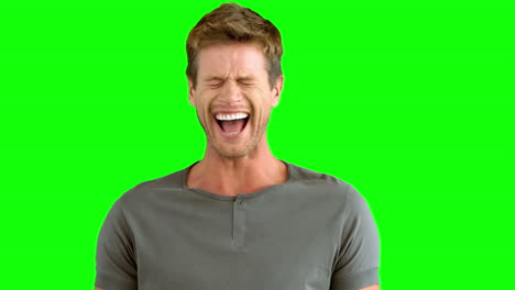 Handsome-man-laughing-on-green-screen