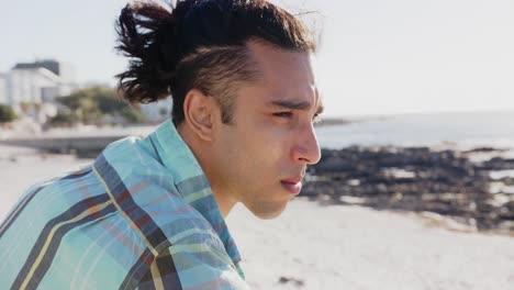 happy biracial man looking away at promenade by the sea, slow motion