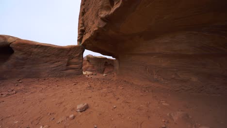 Walking-along-tombs-in-Petra-close-to-The-Treasury-Khaznet,-historic-UNESCO-heritage-site-carved-into-red-rock-sandstone-in-Jordan