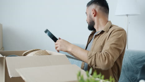 Man unpacking boxes at home