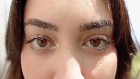 close-up of woman's eyes reflecting joy and warmth during festive celebration