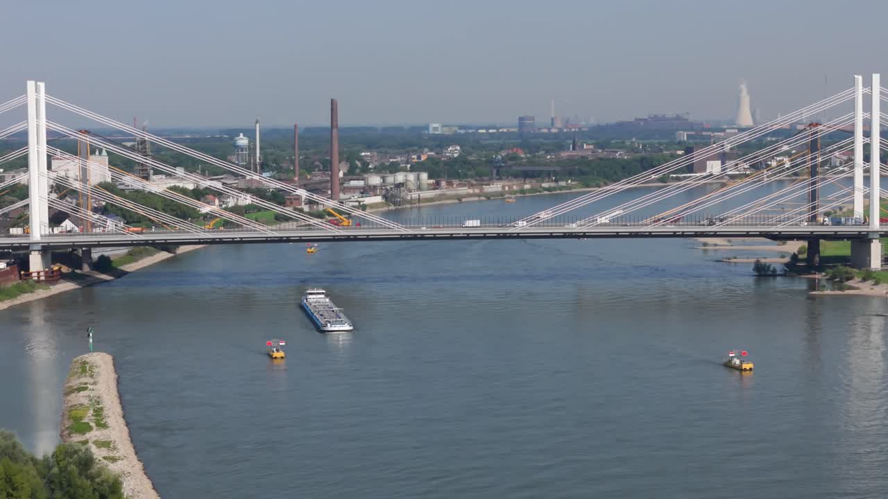 Aerial View of a Cable-Stayed Bridge over a River with Cargo Ships