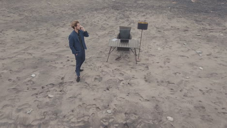 man having phone call working on beach