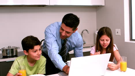 Father-using-the-laptop-with-his-children