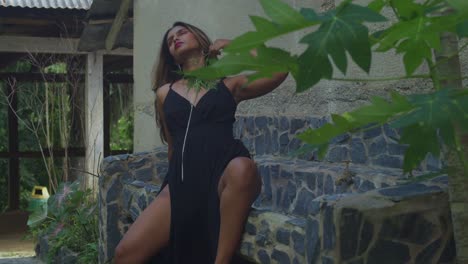 a young girl in a black outfit visiting an ancient complex.