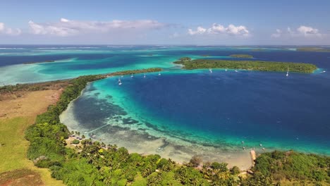 tropical view of vava'u islands surrounded by turquoise water in tonga. aerial, panning shot