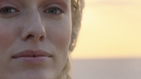 close up portrait of beautiful blonde woman looking confident enjoying relaxed vacation lifestyle feeling freedom on seaside at sunset