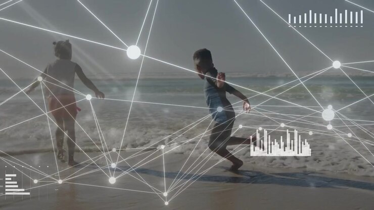 Boy shifting weight, kids playing toward surf and splashing while HUD overlaying passively for tech