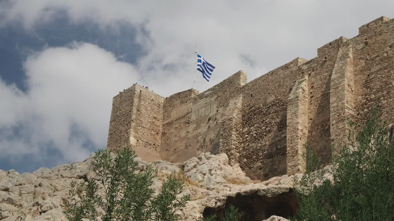 Stunning Greek waving in slow motion on top of stone walls of Acropolis