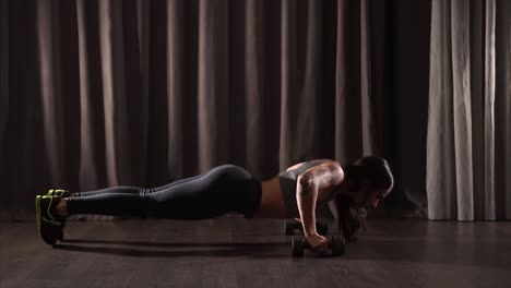 woman doing dumbbell push-ups