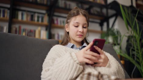 teenage girl texting on smartphone