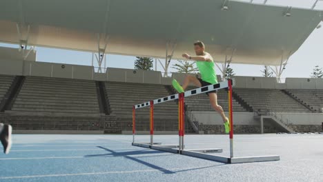 Two-athletes-doing-hurdling-in-stadium