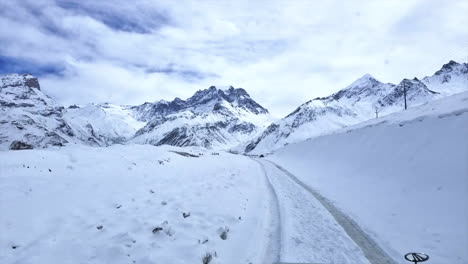 driving on a snow covered mountain road in the heart of the himalayan mountains of nepal