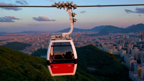 cable car over cityscape at sunrise/sunset