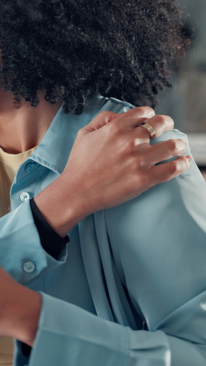 Pensive Woman with Curly Hair Thoughtfully Touching Her Shoulder
