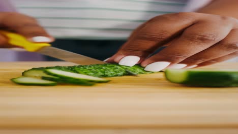 woman cutting cucumber