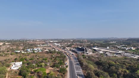 aerial video of developing india: road infrastructure factories corporate videos showcasing logistics, supply chains, or industrial operations. an active industrial area in the highway