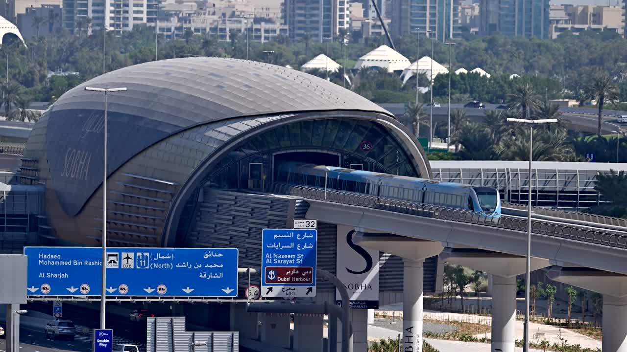 A Dubai Metro train leaves the station, heading to its next stop along Sheikh Zayed Road in Dubai, UAE