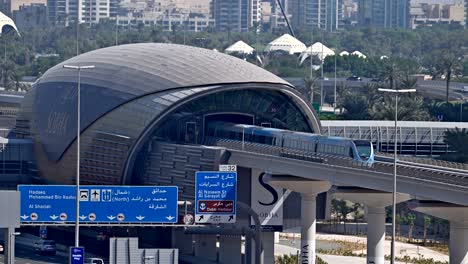a dubai metro train leaves the station, heading to its next stop along sheikh zayed road in dubai, uae