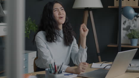 woman celebrating online, happy business professional