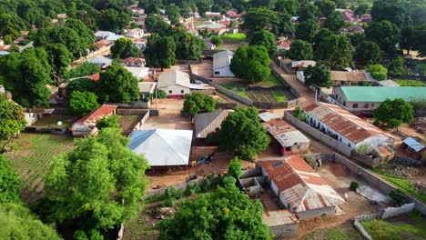 aerial reverse shot of local houses in nuimi lameng african rural village in the gambia