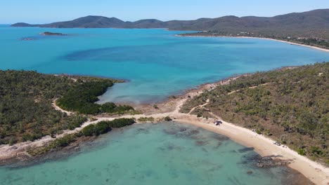 Aerial-View-Of-Blackcurrant-Island,-Dingo-Beach,-And-Seascape-In-Summer---Hideaway-Bay-Ocean-Views-In-Whitsunday,-QLD,-Australia