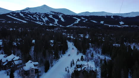 Aerial-view-of-beautiful-snow-covered-hilly-terrain-during-winters-at-sunset