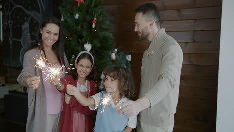 family celebrating christmas with sparkler
