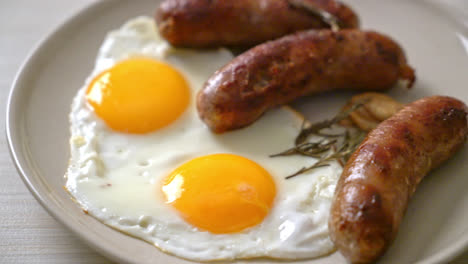 homemade double fried egg with fried pork sausage - for breakfast