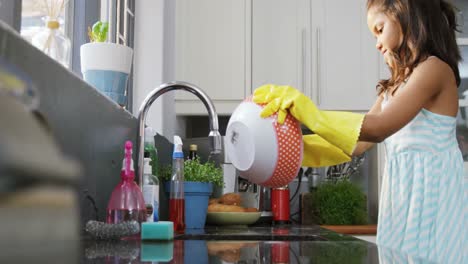 Girl-washing-utensils-in-the-kitchen-4K-4k