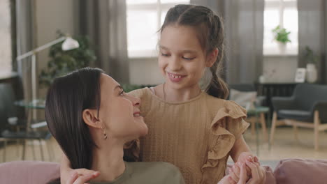 a loving mother and daughter embracing at home