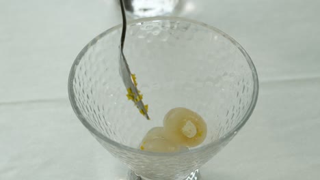making sweet longan fruit dessert in a teh glass dessert cup